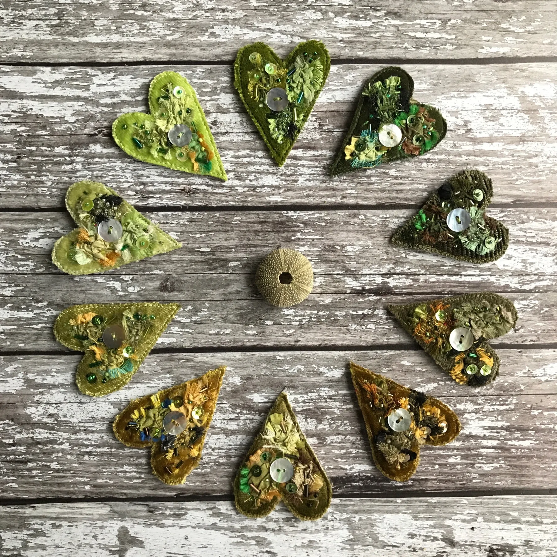 Fabric heart brooches in greens