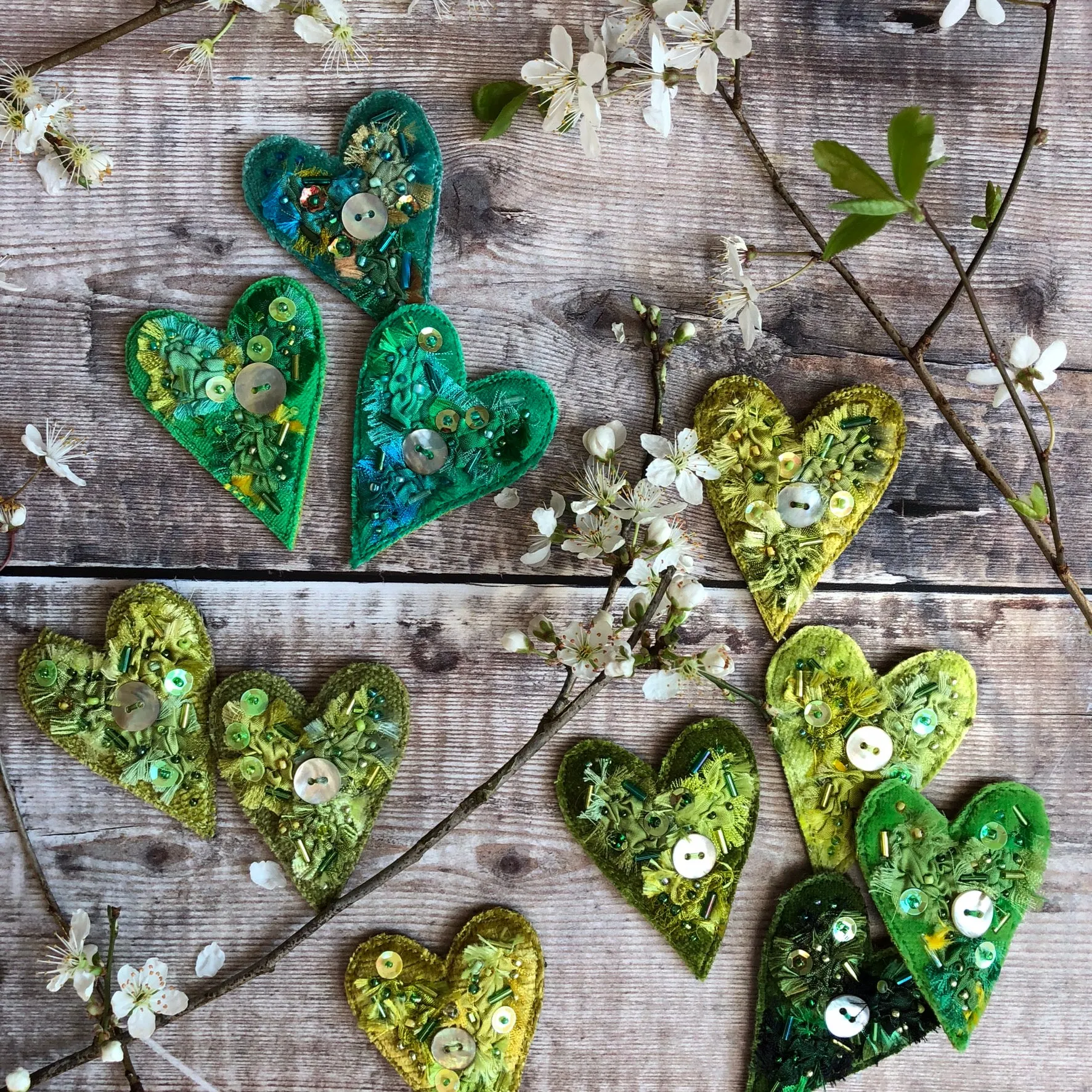 Fabric heart brooches in greens