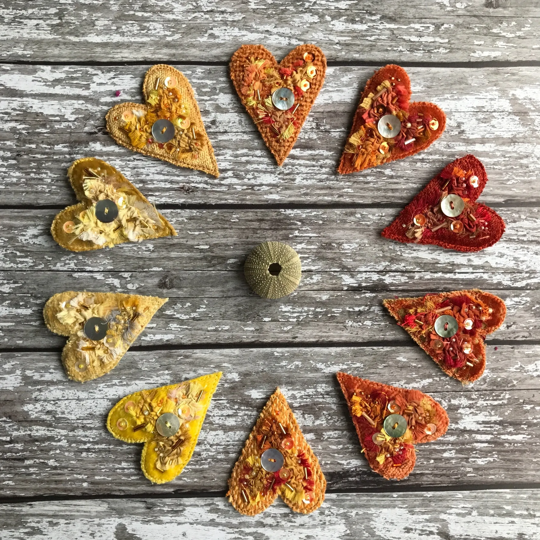 Fabric heart brooches in oranges and yellows