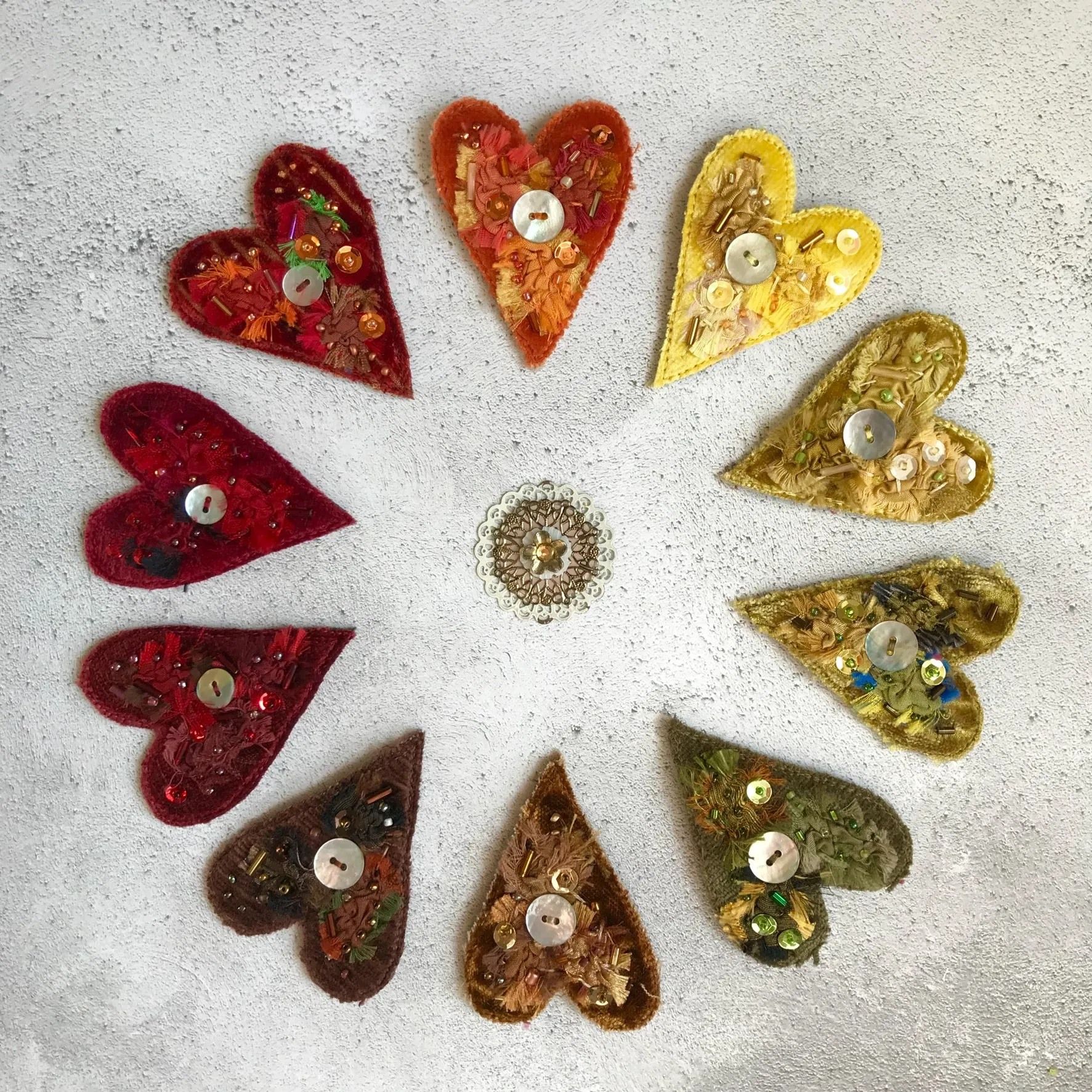 Fabric heart brooches in oranges and yellows
