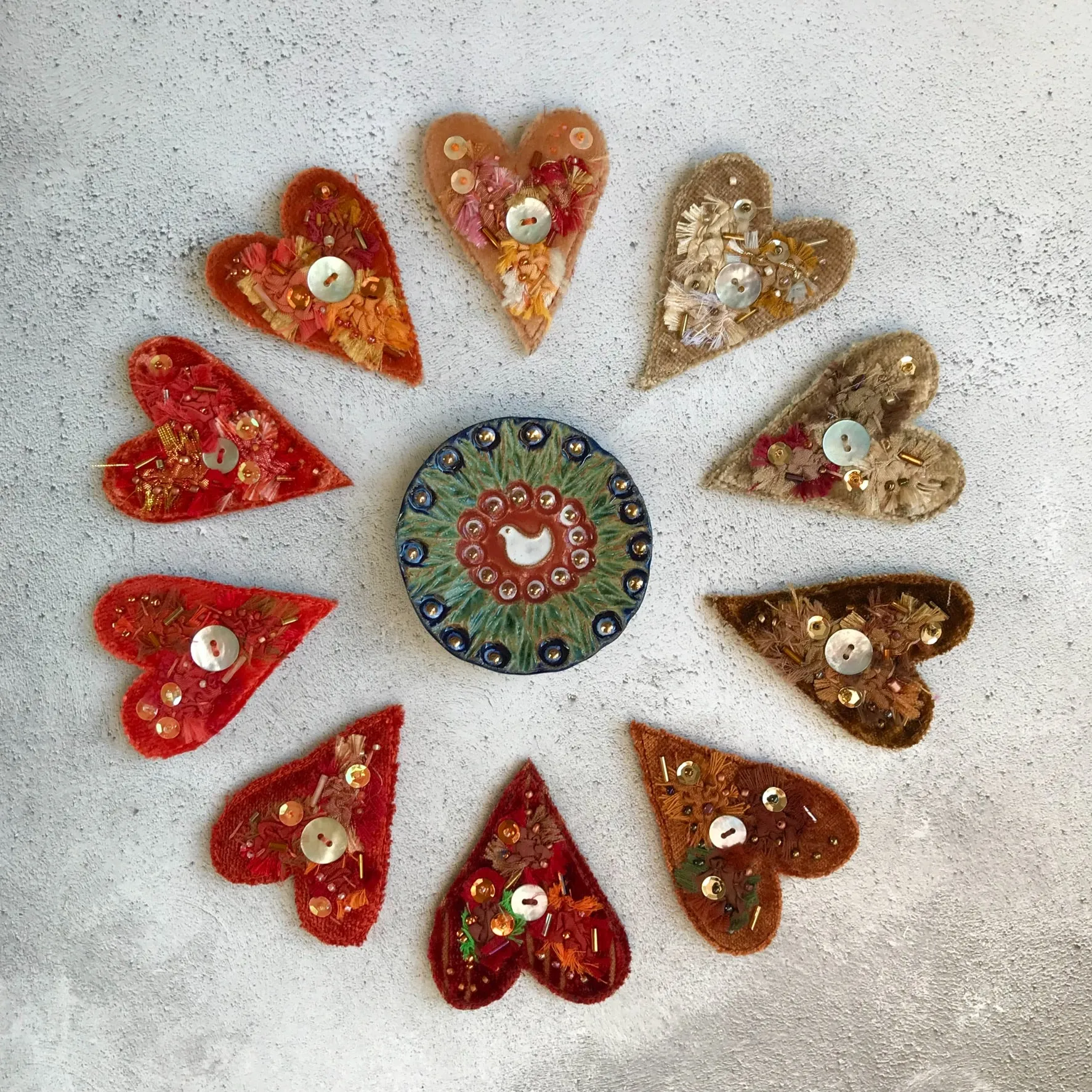 Fabric heart brooches in oranges and yellows