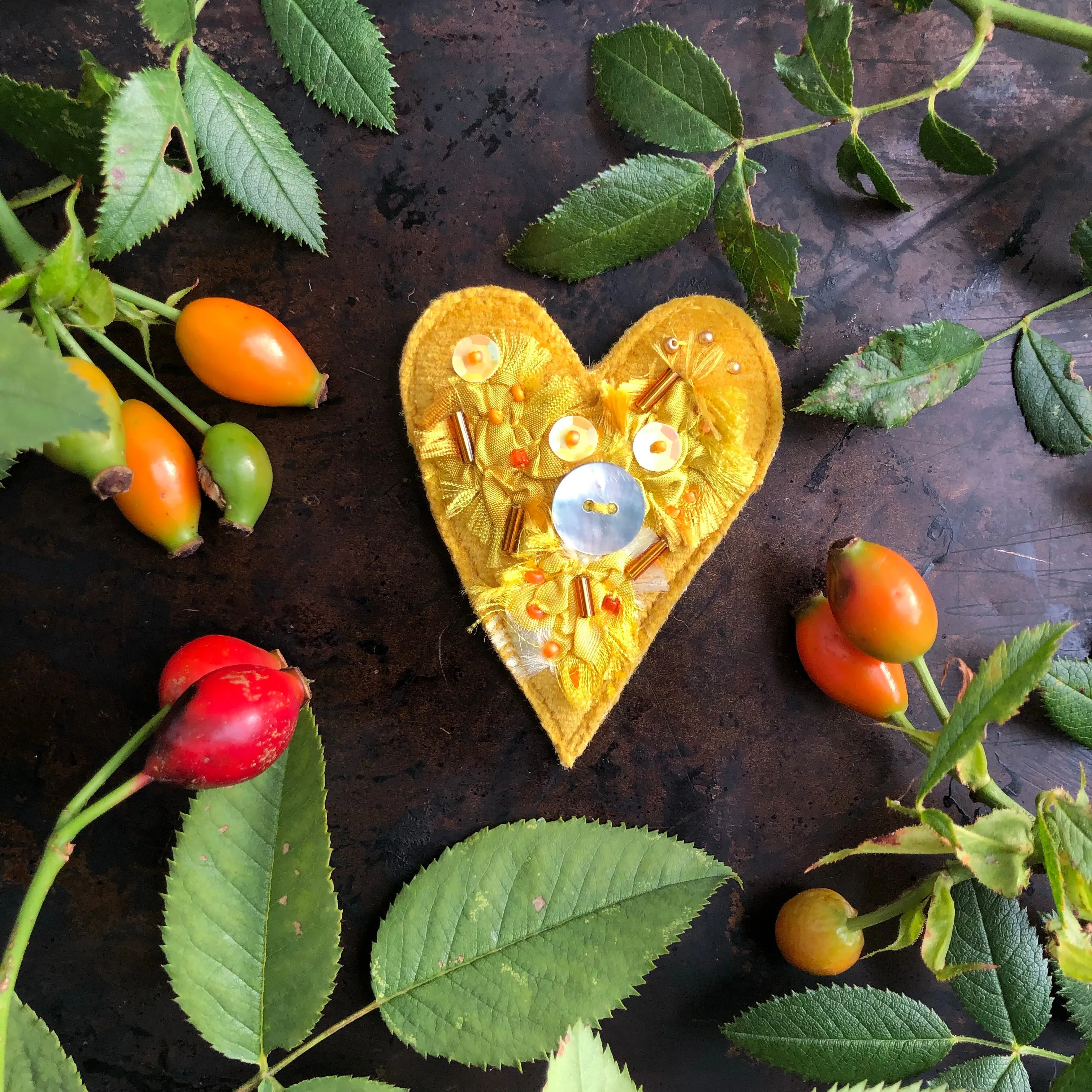 Fabric heart brooches in oranges and yellows